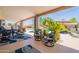 Spacious covered patio for relaxing, offering comfortable seating near the refreshing pool and lush landscaping at 1186 E Brenda Dr, Casa Grande, AZ 85122
