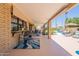 Inviting covered patio area with ample seating and a convenient outdoor bar overlooking the sparkling pool at 1186 E Brenda Dr, Casa Grande, AZ 85122