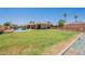 Expansive backyard featuring a sparkling pool, lush lawn, and charming patio area, perfect for outdoor entertaining at 1186 E Brenda Dr, Casa Grande, AZ 85122