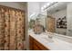 Charming bathroom features a single sink vanity, large mirror, and shower with fun, themed shower curtain at 1186 E Brenda Dr, Casa Grande, AZ 85122