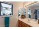 Bright bathroom with window, vanity, and large mirror reflects natural light at 1186 E Brenda Dr, Casa Grande, AZ 85122