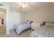 Bright bedroom with two twin beds, ceiling fan, neutral walls, and closet for ample storage at 1186 E Brenda Dr, Casa Grande, AZ 85122