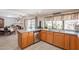 Kitchen with wood cabinets, stainless appliances, island with sink, and views to dining room at 1186 E Brenda Dr, Casa Grande, AZ 85122