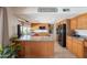 Functional kitchen with wood cabinets, an island, and modern black appliances at 1186 E Brenda Dr, Casa Grande, AZ 85122