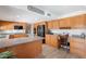 Well-equipped kitchen featuring wooden cabinets, modern appliances, and a desk area at 1186 E Brenda Dr, Casa Grande, AZ 85122