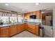 Kitchen with wood cabinets, stainless sink, and a window view of the backyard at 1186 E Brenda Dr, Casa Grande, AZ 85122