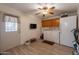 Functional laundry room featuring appliances, overhead cabinets, ceiling fan and access to the backyard at 1186 E Brenda Dr, Casa Grande, AZ 85122