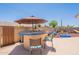 Charming outdoor bar area with seating, perfect for entertaining guests in the backyard play area at 1186 E Brenda Dr, Casa Grande, AZ 85122