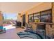 Relaxing covered patio is equipped with a grill, chairs and a pass through bar at 1186 E Brenda Dr, Casa Grande, AZ 85122