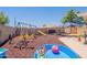 Lovely backyard play area featuring a swing set, slide, seesaw and sandbox for children to enjoy at 1186 E Brenda Dr, Casa Grande, AZ 85122