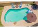 Aerial shot of a refreshing backyard pool with lounge chairs and an umbrella, perfect for summer relaxation at 1186 E Brenda Dr, Casa Grande, AZ 85122