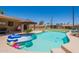 A pristine backyard pool is the central feature, with lounge chairs, mature landscaping, and a charming home exterior at 1186 E Brenda Dr, Casa Grande, AZ 85122