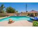 Beautiful backyard pool with lounge chairs, a rock feature, and ample space for relaxing and entertaining at 1186 E Brenda Dr, Casa Grande, AZ 85122