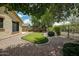 Private backyard with a lush putting green and desert landscaping, perfect for outdoor entertainment at 12775 W Lowden Rd, Peoria, AZ 85383