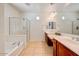 Bright primary bathroom featuring double sinks, tile flooring, and glass enclosed shower at 12775 W Lowden Rd, Peoria, AZ 85383