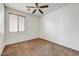 Bedroom with carpet flooring, ceiling fan, and window at 12775 W Lowden Rd, Peoria, AZ 85383