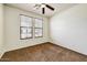 Bedroom with carpeted floors and two windows at 12775 W Lowden Rd, Peoria, AZ 85383