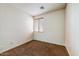 A cozy carpeted bedroom offers a peaceful retreat with natural light from the window at 12775 W Lowden Rd, Peoria, AZ 85383