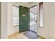 Inviting entryway with neutral walls, security screen door, tile floors, and a welcome wreath at 12775 W Lowden Rd, Peoria, AZ 85383