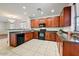 Cozy kitchen featuring dark wood cabinets, granite countertops, and stainless steel appliances at 12775 W Lowden Rd, Peoria, AZ 85383