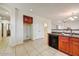 Bright and functional kitchen space with tiled floors and convenient bar seating at 12775 W Lowden Rd, Peoria, AZ 85383