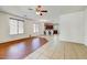 Spacious living room with ceiling fan, a mix of tile and wood flooring, and view to kitchen at 12775 W Lowden Rd, Peoria, AZ 85383