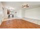 Bright open space with a ceiling fan that connects to a kitchen with a breakfast bar at 12775 W Lowden Rd, Peoria, AZ 85383