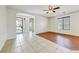 Open living room featuring tile flooring, a ceiling fan, and natural light from large windows at 12775 W Lowden Rd, Peoria, AZ 85383