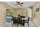 Bright dining room with a modern table and sliding glass doors leading to the backyard at 12903 W Brookhart Way, Peoria, AZ 85383