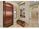 Welcoming entryway with tiled floor, bench seating, and view to home office at 12903 W Brookhart Way, Peoria, AZ 85383