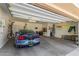Spacious garage with a blue sports car, ample storage, and overhead lighting at 12903 W Brookhart Way, Peoria, AZ 85383