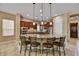 Open kitchen features a breakfast bar, stainless steel appliances, and granite countertops at 12903 W Brookhart Way, Peoria, AZ 85383