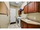 A dedicated laundry room with a washer, dryer, and utility sink at 12903 W Brookhart Way, Peoria, AZ 85383