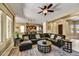 Stylish living room with tiled floors, a leather sectional, and ample natural light at 12903 W Brookhart Way, Peoria, AZ 85383
