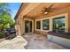 Covered patio with ceiling fan, hot tub, grill, and desert landscaping at 12903 W Brookhart Way, Peoria, AZ 85383