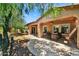 Landscaped backyard with a covered patio, grill, and stone walkway at 12903 W Brookhart Way, Peoria, AZ 85383