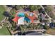 Aerial view of a community pool featuring palm trees, shade structures, lounge chairs, and pristine blue water at 12903 W Brookhart Way, Peoria, AZ 85383