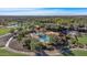 Aerial view showcasing the pool area, lush landscaping, and a nearby building at a community at 12903 W Brookhart Way, Peoria, AZ 85383