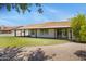 Expansive backyard with covered patio, lush lawn and mature trees at 13010 S 42Nd St, Phoenix, AZ 85044