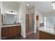 Bathroom with a walk-in shower, dual sinks with wood cabinetry and tile flooring at 13010 S 42Nd St, Phoenix, AZ 85044