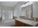 Bathroom featuring a soaking tub, wood vanity and tile accents at 13010 S 42Nd St, Phoenix, AZ 85044