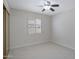 Neutral bedroom with a ceiling fan, shutters, and carpeted floor at 13010 S 42Nd St, Phoenix, AZ 85044