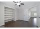 Bright bedroom with built-in shelves, fan, and wood-look tile flooring at 13010 S 42Nd St, Phoenix, AZ 85044