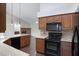 Open kitchen features granite countertops, tile backsplash, and black appliances at 13010 S 42Nd St, Phoenix, AZ 85044