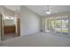 Bright main bedroom with carpet flooring, ceiling fan and sliding doors to access to outdoor space at 13010 S 42Nd St, Phoenix, AZ 85044