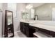 Bathroom vanity featuring wood cabinets and an attached makeup table with seat at 13153 W Cottontail Ln, Peoria, AZ 85383