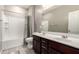 Bathroom featuring double sinks and a tiled shower with a tub, offering a clean and functional design at 13153 W Cottontail Ln, Peoria, AZ 85383