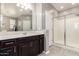 Bathroom with tiled floors, large vanity, and a glass-enclosed shower for a spa-like experience at 13153 W Cottontail Ln, Peoria, AZ 85383