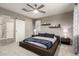 Modern bedroom with a unique bed frame, neutral colors, and sliding barn door to bathroom at 13153 W Cottontail Ln, Peoria, AZ 85383