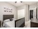 Well-lit bedroom with carpet flooring, sports-themed decor, and a closet at 13153 W Cottontail Ln, Peoria, AZ 85383